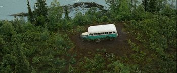 Movie still from “Into the Wild” (2007), directed by Sean Penn – An old bus is parked on the side of a river; Extreme Wide shot, High angle