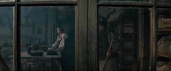 Movie still from “Into the Woods” (2014), directed by Rob Marshall – A woman standing in front of a window with a man holding a stick; Medium shot, Over the shoulder angle