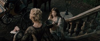 Movie still from “Into the Woods” (2014), directed by Rob Marshall – Two women in medieval garb looking at each other; Medium shot, High angle