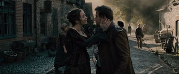 Movie still from “Into the Woods” (2014), directed by Rob Marshall – A man and a woman standing next to each other on a street; Medium shot, Over the shoulder angle