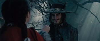Movie still from “Into the Woods” (2014), directed by Rob Marshall – A man in a hat and a tie is looking at another man in a hat and a tie; Close Up shot, Over the shoulder angle