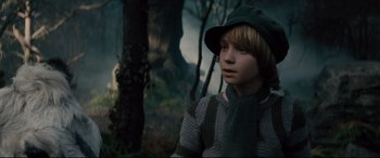Movie still from “Into the Woods” (2014), directed by Rob Marshall – A boy in a hat and scarf in the woods; Medium shot, Low angle