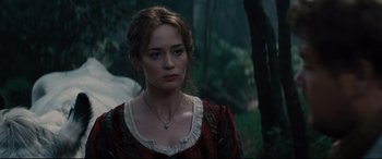 Movie still from “Into the Woods” (2014), directed by Rob Marshall – A woman in a red and black dress standing in a forest; Close Up shot, Over the shoulder angle