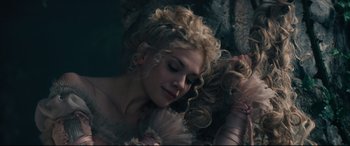 Movie still from “Into the Woods” (2014), directed by Rob Marshall – A beautiful young lady with blonde curly hair; Close Up shot, High angle