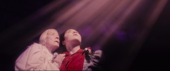 Movie still from “Into the Woods” (2014), directed by Rob Marshall – An older woman and a younger woman looking up at the sky; Medium shot, Low angle