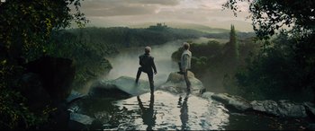 Movie still from “Into the Woods” (2014), directed by Rob Marshall – Two people standing on rocks in a body of water; Wide shot, Low angle