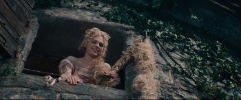 Movie still from “Into the Woods” (2014), directed by Rob Marshall – A woman with blonde hair is sitting on a rock; Medium shot, High angle