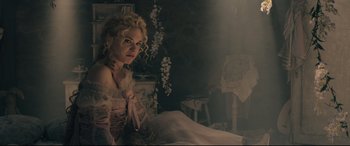 Movie still from “Into the Woods” (2014), directed by Rob Marshall – A woman sitting on a bed in a dark room; Medium shot, Low angle