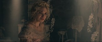 Movie still from “Into the Woods” (2014), directed by Rob Marshall – A woman with curly blonde hair wearing a pink dress; Close Up shot, Over the shoulder angle