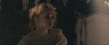 Movie still from “Into the Woods” (2014), directed by Rob Marshall – A woman with curly blonde hair wearing a white dress; Close Up shot, Over the shoulder angle