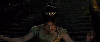 Movie still from “Into the Woods” (2014), directed by Rob Marshall – A person wearing a gold dress; Close Up shot, High angle