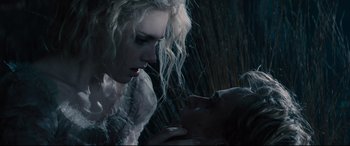 Movie still from “Into the Woods” (2014), directed by Rob Marshall – A woman and a man kissing in the rain; Close Up shot, Over the shoulder angle