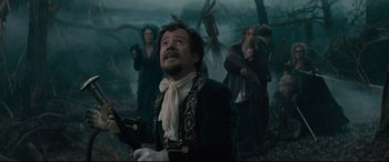 Movie still from “Into the Woods” (2014), directed by Rob Marshall – A group of people standing in a forest; Medium shot, Low angle