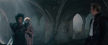 Movie still from “Into the Woods” (2014), directed by Rob Marshall – A man standing under an arch in the middle of a building; Wide shot, Low angle