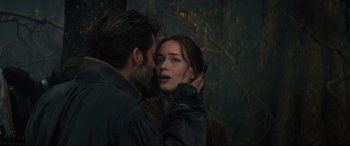 Movie still from “Into the Woods” (2014), directed by Rob Marshall – A man and a woman are kissing in a dark forest; Close Up shot, Over the shoulder angle