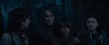 Movie still from “Into the Woods” (2014), directed by Rob Marshall – A woman standing next to a young boy in a forest; Medium shot, Over the shoulder angle