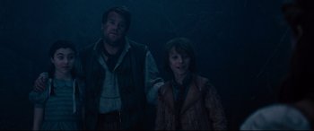 Movie still from “Into the Woods” (2014), directed by Rob Marshall – A man and a boy standing next to each other in the dark; Medium shot, Over the shoulder angle