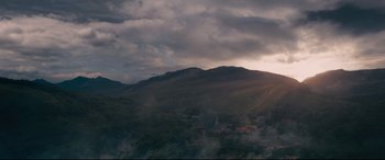 Movie still from “Into the Woods” (2014), directed by Rob Marshall – The sun is setting over a mountain range; Extreme Wide shot, Low angle