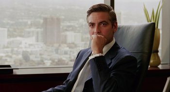 Movie still from “Intolerable Cruelty” (2003), directed by Joel Coen – A person wearing a suit and tie; Close Up shot, Over the shoulder angle