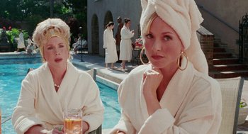 Movie still from “Intolerable Cruelty” (2003), directed by Joel Coen – Two women in white bathrobes sitting next to a pool; Close Up shot, Over the shoulder angle