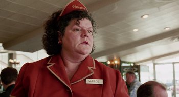 Movie still from “Intolerable Cruelty” (2003), directed by Joel Coen – A woman wearing a red uniform and a red hat; Close Up shot, Low angle
