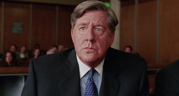 Movie still from “Intolerable Cruelty” (2003), directed by Joel Coen – A person wearing a suit and tie; Close Up shot, Low angle