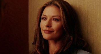 Movie still from “Intolerable Cruelty” (2003), directed by Joel Coen – A person with long brown hair; Close Up shot, Over the shoulder angle