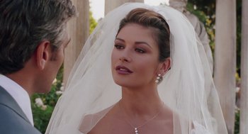 Movie still from “Intolerable Cruelty” (2003), directed by Joel Coen – A woman wearing a wedding veil looking at the camera; Close Up shot, Over the shoulder angle