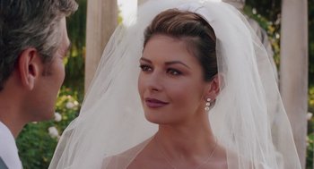 Movie still from “Intolerable Cruelty” (2003), directed by Joel Coen – A woman in a wedding dress with a veil; Close Up shot, Over the shoulder angle