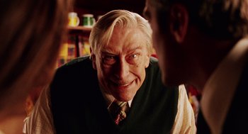 Movie still from “Intolerable Cruelty” (2003), directed by Joel Coen – An older man wearing a vest and a tie; Close Up shot, Over the shoulder angle