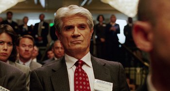 Movie still from “Intolerable Cruelty” (2003), directed by Joel Coen – An older man wearing a suit and tie; Close Up shot, Over the shoulder angle