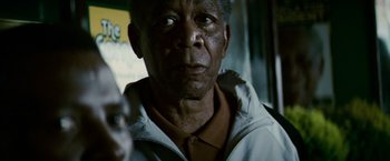 Movie still from “Invictus” (2009), directed by Clint Eastwood – An older man is looking into the camera; Close Up shot, Low angle