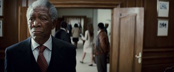 Movie still from “Invictus” (2009), directed by Clint Eastwood – A group of people standing in a room; Close Up shot, Over the shoulder angle