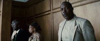 Movie still from “Invictus” (2009), directed by Clint Eastwood – A man and a woman standing next to each other in a room; Close Up shot, Low angle