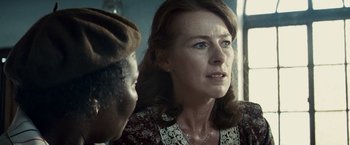 Movie still from “Invictus” (2009), directed by Clint Eastwood – An older woman is looking at a younger man; Close Up shot, Over the shoulder angle