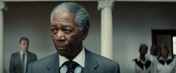 Movie still from “Invictus” (2009), directed by Clint Eastwood – An older man wearing a suit and tie; Close Up shot, Low angle