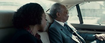 Movie still from “Invictus” (2009), directed by Clint Eastwood – An older man and a young woman in the back seat of a car; Close Up shot, Low angle