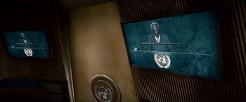 Movie still from “Invictus” (2009), directed by Clint Eastwood – A man in a suit is speaking at the un; Medium shot, Low angle