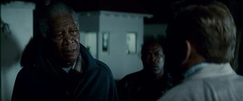 Movie still from “Invictus” (2009), directed by Clint Eastwood – Two men standing next to each other in front of a building; Close Up shot, Over the shoulder angle