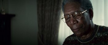 Movie still from “Invictus” (2009), directed by Clint Eastwood – An older man wearing glasses looking down at the ground; Close Up shot, Low angle