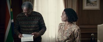 Movie still from “Invictus” (2009), directed by Clint Eastwood – An older man and a young woman are looking at each other in front of a window; Medium shot, Over the shoulder angle
