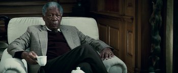 Movie still from “Invictus” (2009), directed by Clint Eastwood – An older man sitting in a chair in a room; Close Up shot, Low angle