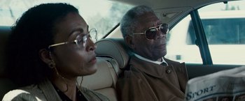 Movie still from “Invictus” (2009), directed by Clint Eastwood – An older man and a younger woman in a car; Close Up shot, Low angle