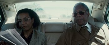 Movie still from “Invictus” (2009), directed by Clint Eastwood – A man and a woman sitting in the back of a car; Close Up shot, Over the shoulder angle