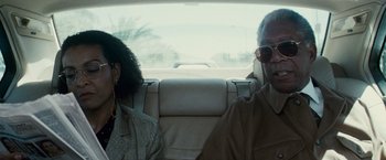 Movie still from “Invictus” (2009), directed by Clint Eastwood – A man and a woman sitting in the back of a car; Close Up shot, Over the shoulder angle