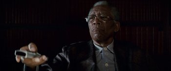 Movie still from “Invictus” (2009), directed by Clint Eastwood – An older man wearing glasses and a suit; Close Up shot, Low angle