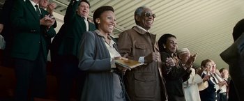 Movie still from “Invictus” (2009), directed by Clint Eastwood – A man and a woman are laughing together; Medium shot, Low angle
