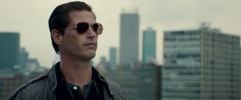 Movie still from “Invictus” (2009), directed by Clint Eastwood – A person wearing sunglasses and a jacket; Close Up shot, Low angle