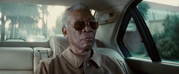 Movie still from “Invictus” (2009), directed by Clint Eastwood – An older man wearing sunglasses sitting in the back of a car; Close Up shot, Low angle