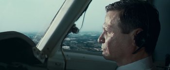 Movie still from “Invictus” (2009), directed by Clint Eastwood – A man looking out the window of an airplane; Close Up shot, Low angle